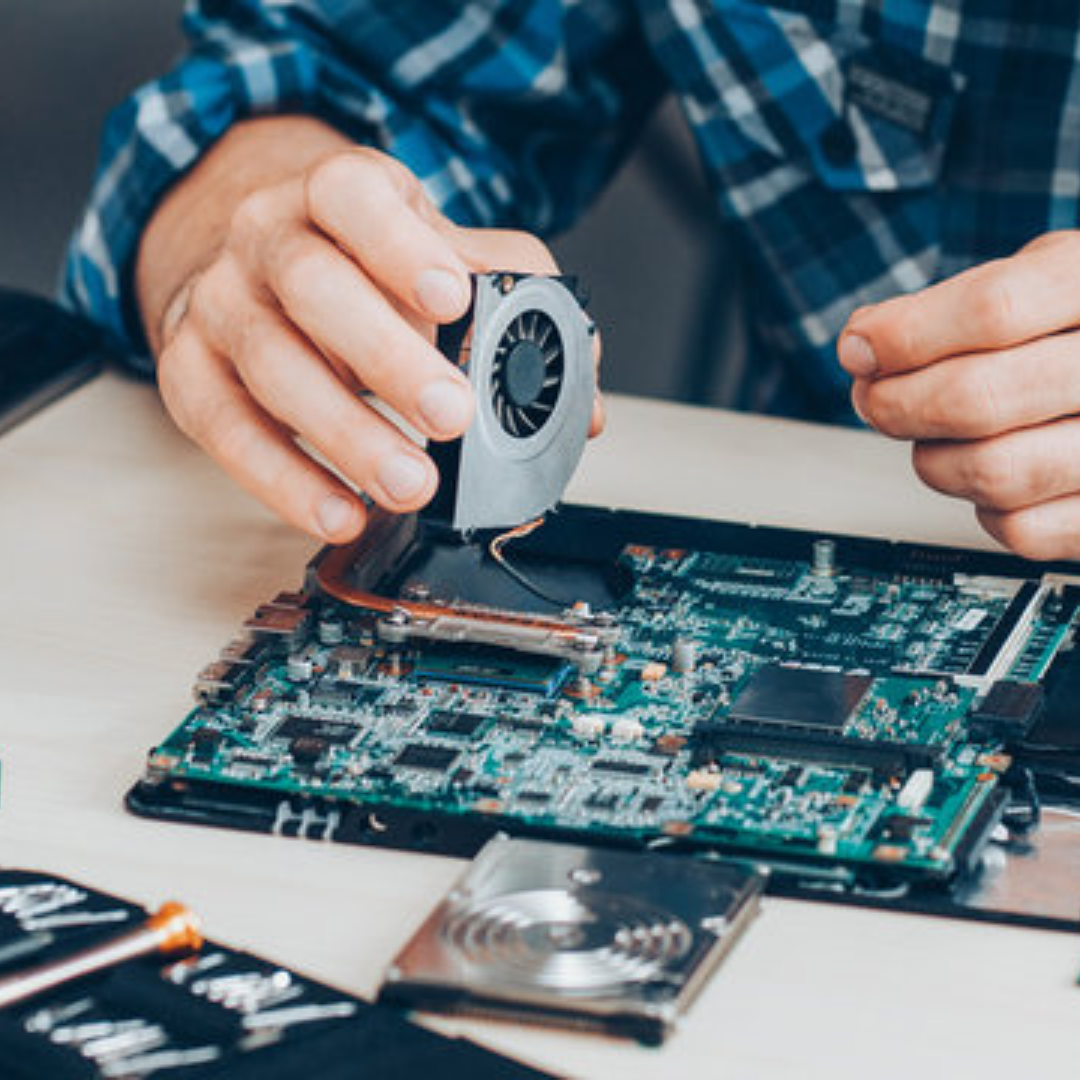 Technician performing laptop repair at Smoke Plus in Renton, WA