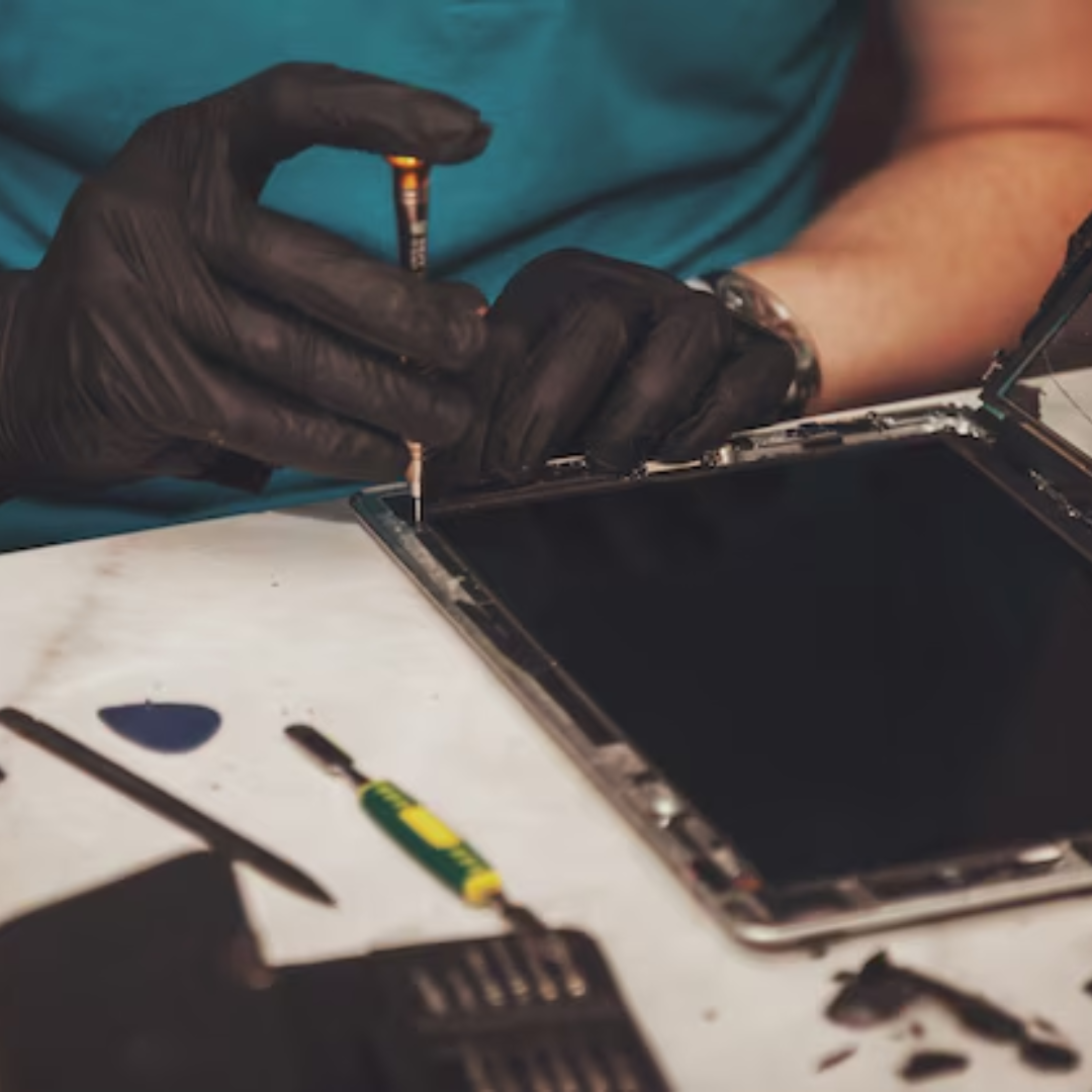 A technician repairing a phone or tablet at Smoke Plus in Renton, WA